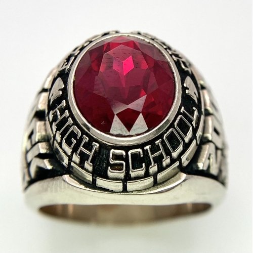 304 - A 10K White Gold and Ruby Gents High School Ring. Size P 1/2. 18g total weight. Ref: 17043