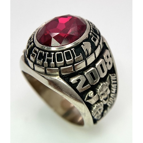 304 - A 10K White Gold and Ruby Gents High School Ring. Size P 1/2. 18g total weight. Ref: 17043