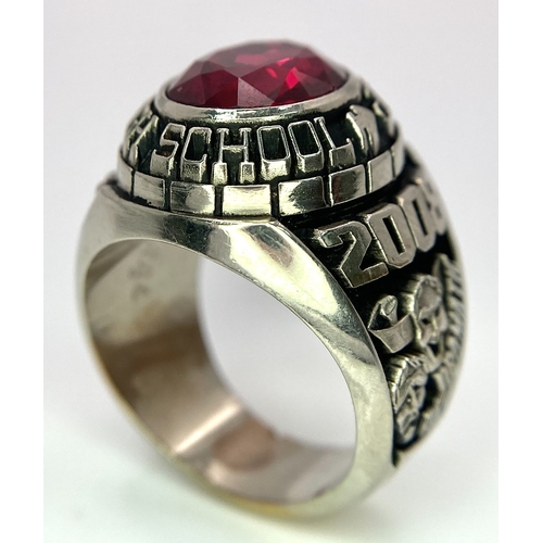 304 - A 10K White Gold and Ruby Gents High School Ring. Size P 1/2. 18g total weight. Ref: 17043