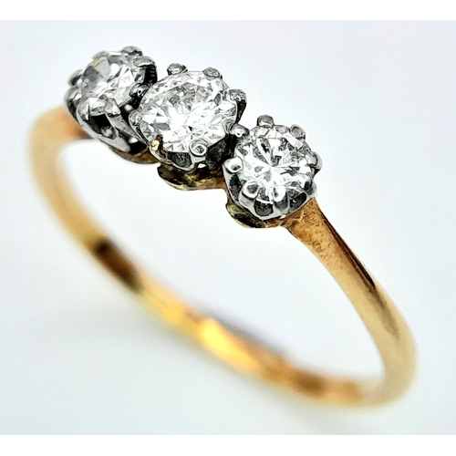 278 - AN 18K YELLOW GOLD DIAMOND 3 STONE RING. 0.30CT. 1.4G. SIZE J.