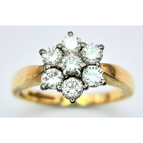 289 - An 18K Yellow Gold Diamond Ring. Seven diamonds in a floral shape - 0.7ctw. Size O. 4.2g total weigh... 