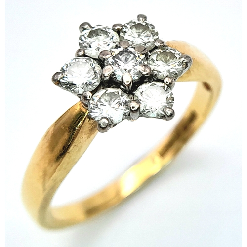 289 - An 18K Yellow Gold Diamond Ring. Seven diamonds in a floral shape - 0.7ctw. Size O. 4.2g total weigh... 