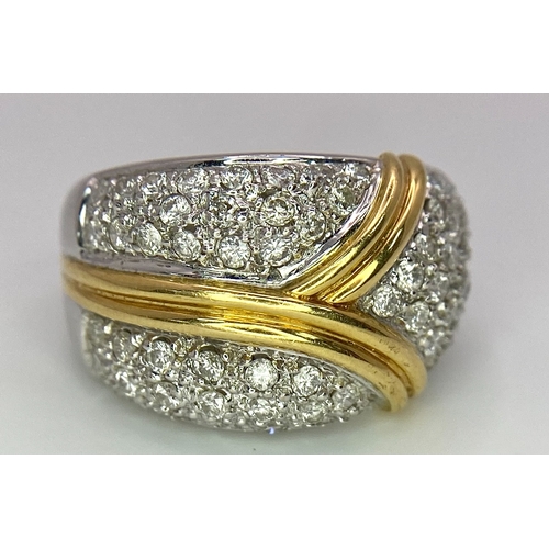 282 - An 18K White and Yellow Gold Diamond Cluster Ring. Three small fields of diamonds separated by golde... 