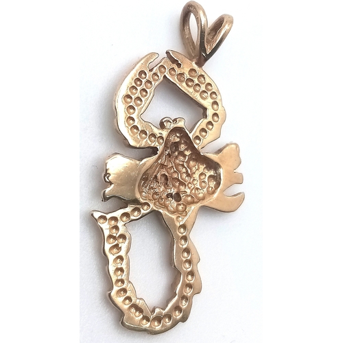 596 - A 9K YELLOW GOLD DIAMOND SET SCORPION CHARM. 2.8cm length, 2.1g total weight. Ref: SC 8009