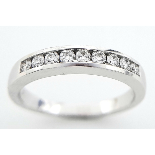 123 - AN 18K WHITE GOLD DIAMOND BAND RING. 0.25CT. 4.1G. SIZE N