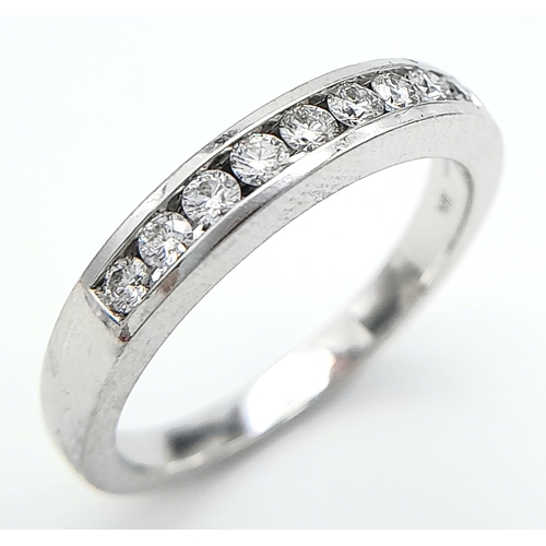 123 - AN 18K WHITE GOLD DIAMOND BAND RING. 0.25CT. 4.1G. SIZE N