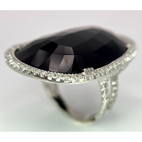 11 - A Beautiful 18k White Gold Black Onyx and Diamond Ladies Dress Ring. Faceted black onyx with a diamo... 