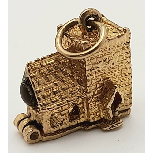 717 - A 9 K yellow gold charm in the shape of a chapel, which opens to reveal a wedding ceremony, dimensio... 