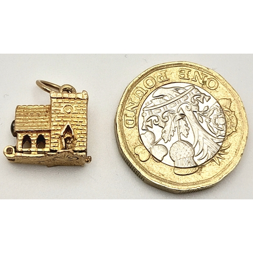 717 - A 9 K yellow gold charm in the shape of a chapel, which opens to reveal a wedding ceremony, dimensio... 