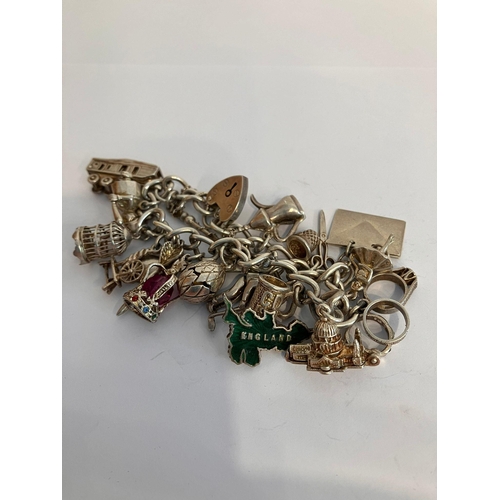 329 - Vintage SILVER CHARM BRACELET complete with safety chain , to include 18 x interesting and unusual c... 