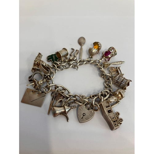 329 - Vintage SILVER CHARM BRACELET complete with safety chain , to include 18 x interesting and unusual c... 