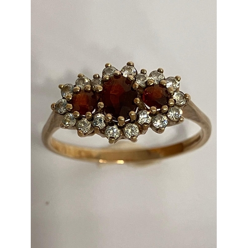 98 - Stunning 9 carat GOLD and GARNET TRILOGY RING. Having 3 x oval and round cut Garnets set to top. Spa... 