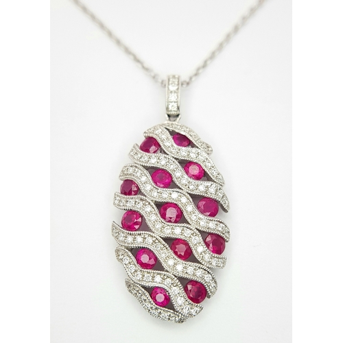 26 - AN 18K WHITE GOLD DIAMOND AND RUBY PENDANT - 0.49CT OF DIAMONDS AND 2.29CT OF RUBIES. 6.2G WEIGHT. D... 