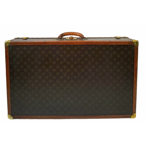 38 - A Vintage Possibly Antique Louis Vuitton Trunk/Hard Suitcase. Canvas monogram LV exterior with quatr... 