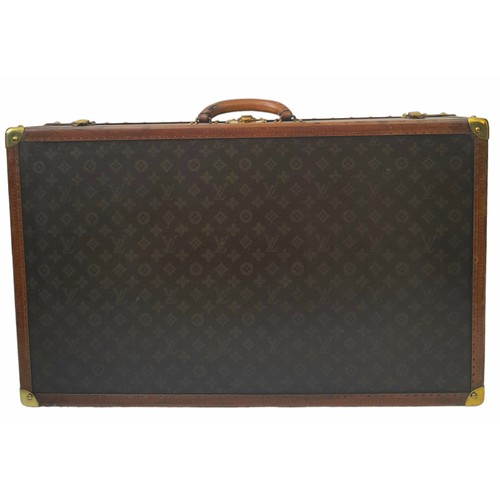 38 - A Vintage Possibly Antique Louis Vuitton Trunk/Hard Suitcase. Canvas monogram LV exterior with quatr... 