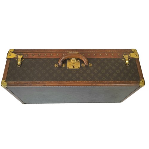 38 - A Vintage Possibly Antique Louis Vuitton Trunk/Hard Suitcase. Canvas monogram LV exterior with quatr... 