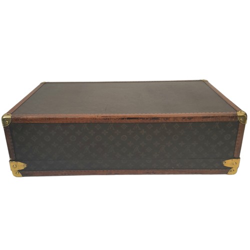 38 - A Vintage Possibly Antique Louis Vuitton Trunk/Hard Suitcase. Canvas monogram LV exterior with quatr... 