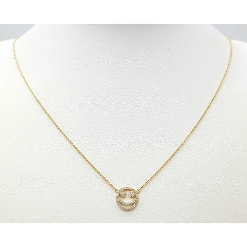 25 - An 18K Gold Diamond Smiley Face Pendant on an 18K Yellow Gold Disappearing Necklace. 1cm diameter pe... 