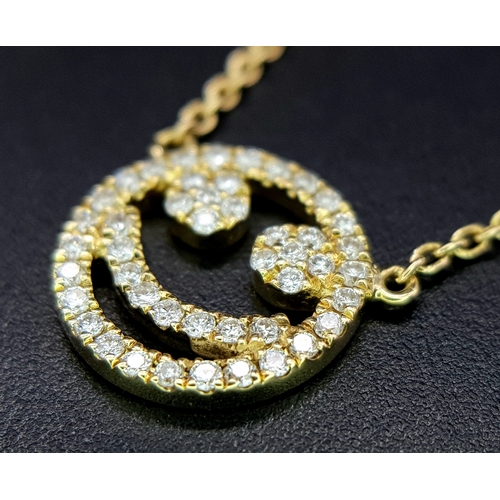 25 - An 18K Gold Diamond Smiley Face Pendant on an 18K Yellow Gold Disappearing Necklace. 1cm diameter pe... 