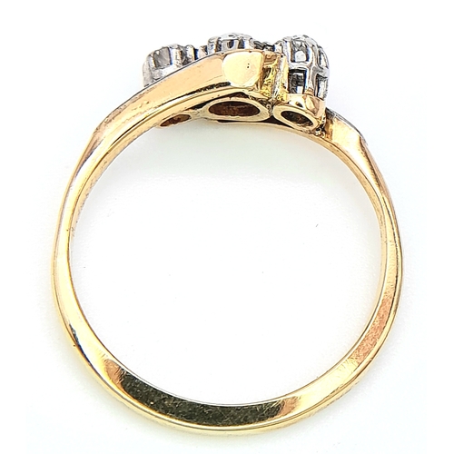 558 - AN 18K YELLOW GOLD, DIAMOND SET, CROSSOVER 3 STONE RING. 0.25CT. 2.8G. SIZE L