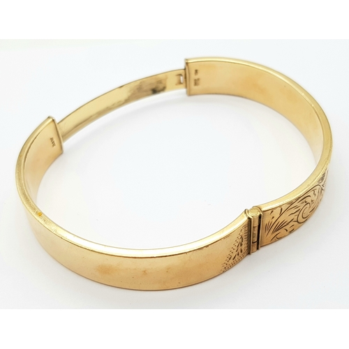 636 - A 9K GOLD VINTAGE HINGED BANGLE WITH A METAL CORE .   23.9gms