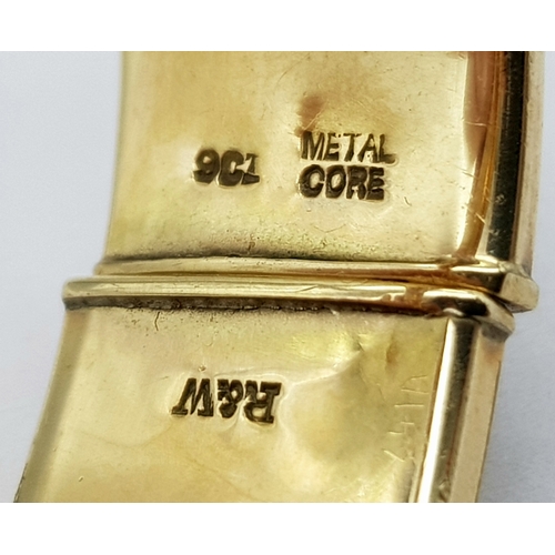 636 - A 9K GOLD VINTAGE HINGED BANGLE WITH A METAL CORE .   23.9gms