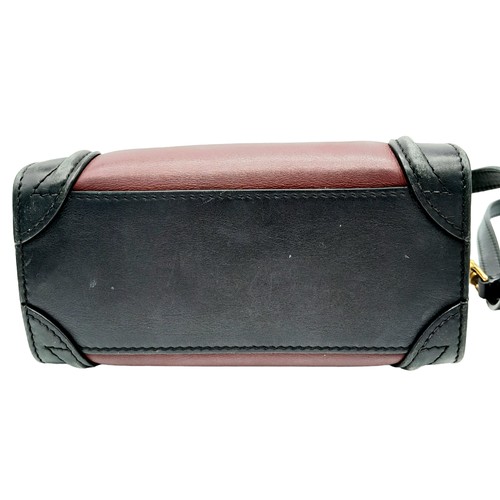 522 - A Celine Tri Colour Hand/Shoulder Bag. Burgundy and black leather exterior with soft textile sides. ... 