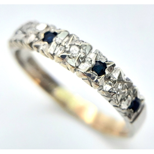 705 - A 9K WHITE GOLD DIAMOND AND SAPPHIRE RING. 2.1G. SIZE O