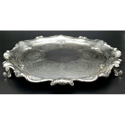 1848 - A 761gms solid silver Salva with scrolled edges and hand chased intricate decoration and hallmarked ... 