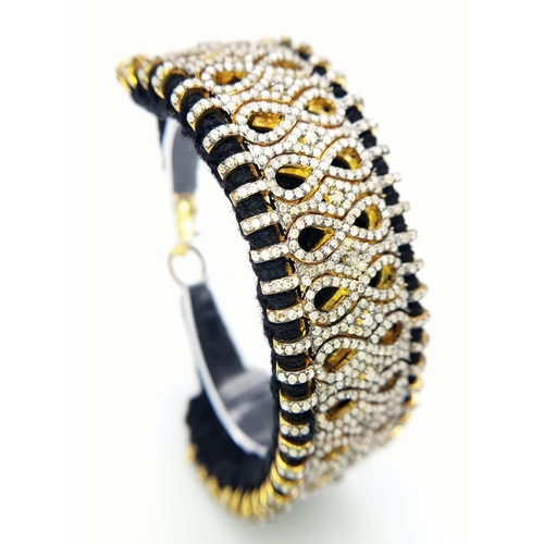 147 - A Brilliantly Unique Handcrafted Designer Diamond Bracelet. A black woven textile bracelet strap ado... 