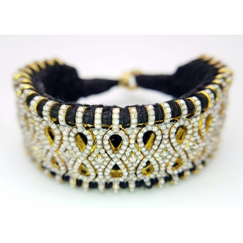147 - A Brilliantly Unique Handcrafted Designer Diamond Bracelet. A black woven textile bracelet strap ado... 
