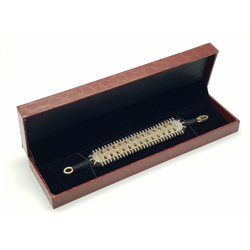 147 - A Brilliantly Unique Handcrafted Designer Diamond Bracelet. A black woven textile bracelet strap ado... 
