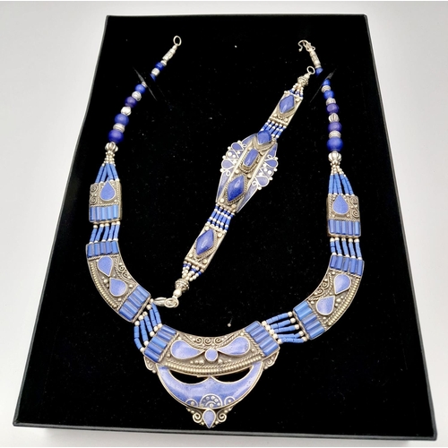 103 - A tribal, wonderfully crafted, white metal and lapis lazuli necklace and bracelet set in a presentat... 