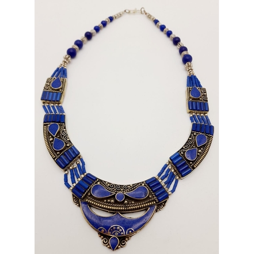 103 - A tribal, wonderfully crafted, white metal and lapis lazuli necklace and bracelet set in a presentat... 