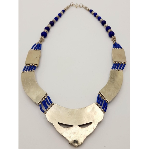 103 - A tribal, wonderfully crafted, white metal and lapis lazuli necklace and bracelet set in a presentat... 