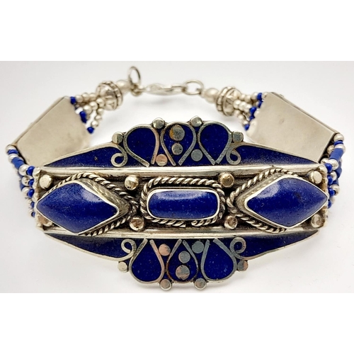 103 - A tribal, wonderfully crafted, white metal and lapis lazuli necklace and bracelet set in a presentat... 