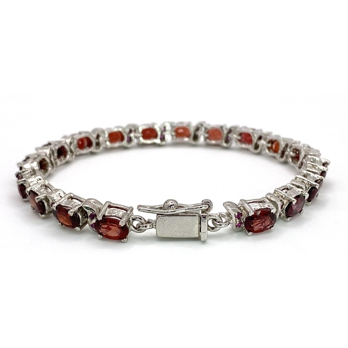 105 - A Garnet Tennis Bracelet set in 925 Sterling silver. 36ctw. W-25.60g. 18cm.