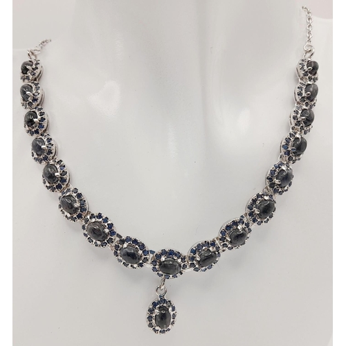 112 - A Blue Sapphire Silver Choker Necklace with Matching Drop Earrings. Both set in 925 sterling silver.... 