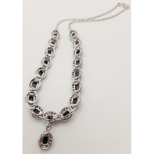 112 - A Blue Sapphire Silver Choker Necklace with Matching Drop Earrings. Both set in 925 sterling silver.... 