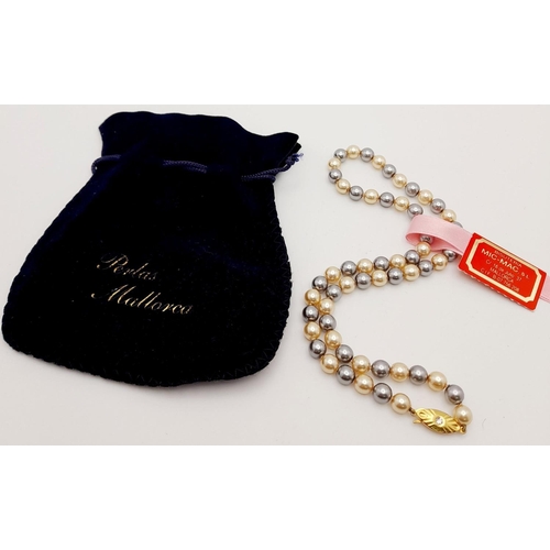 131 - A truly elegant, 14 K yellow gold plated, Mallorca pearl necklace, with alternating metallic grey an... 