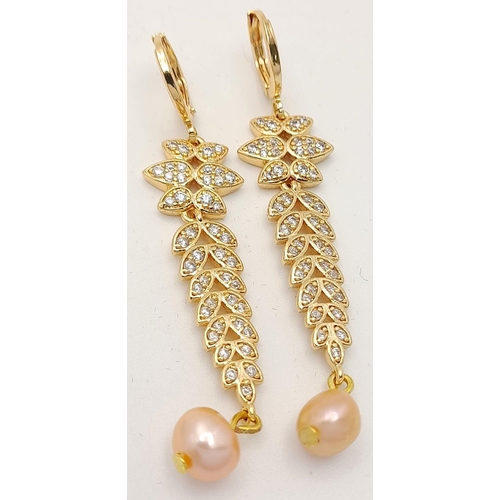 138 - A fabulous gold-plated pair of earrings with cubic zirconia and pink cultured pearls, presented in a... 