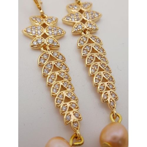 138 - A fabulous gold-plated pair of earrings with cubic zirconia and pink cultured pearls, presented in a... 