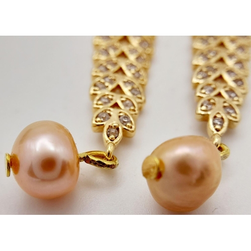 138 - A fabulous gold-plated pair of earrings with cubic zirconia and pink cultured pearls, presented in a... 