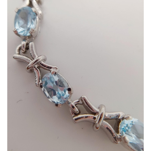 231 - A  Blue Topaz Tennis Bracelet. Set in 925 Sterling Silver. 28ctw. W-17.60g. 18cm. HV -2169.