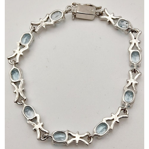 231 - A  Blue Topaz Tennis Bracelet. Set in 925 Sterling Silver. 28ctw. W-17.60g. 18cm. HV -2169.