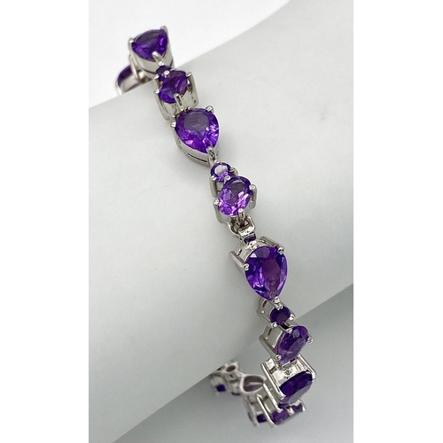 245 - An Amethyst Tennis Bracelet. Set in 925 Sterling Silver. 27ctw. W-17.20g.19cm. Ref: HV-2170