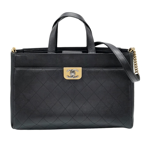 598 - A Chanel black quilted caviar leather straight line tote bag. Silver and gold tone hardware, studded... 