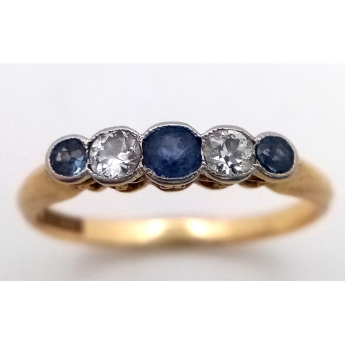 12 - An 18K Gold (tested) Diamond and Pale Blue Sapphire Ring. Size O. 2.6g total weight.