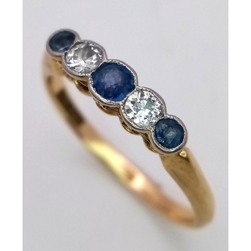 12 - An 18K Gold (tested) Diamond and Pale Blue Sapphire Ring. Size O. 2.6g total weight.