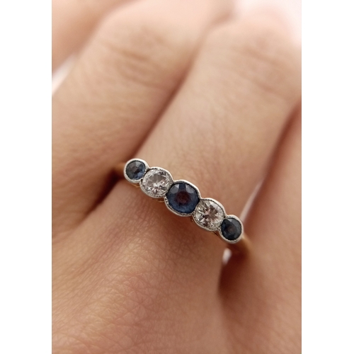 12 - An 18K Gold (tested) Diamond and Pale Blue Sapphire Ring. Size O. 2.6g total weight.